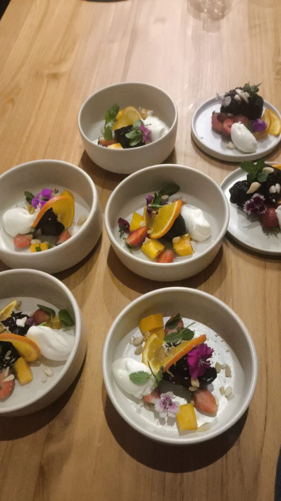 Dessert bowls photographed from above with edible flowers