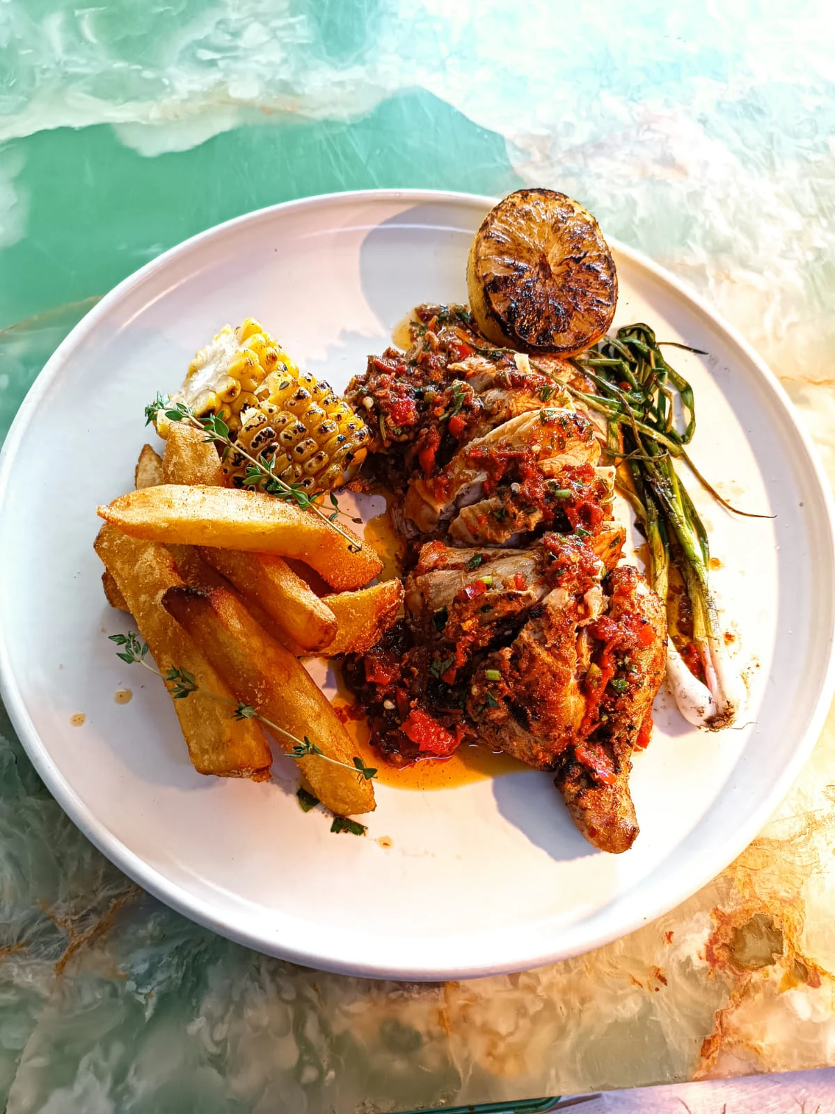Grilled chicken with sambal, thick-cut fries, charred corn and lime