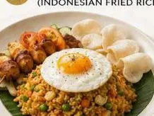 Nasi goreng topped with a fried egg, served with chicken satay and prawn crackers