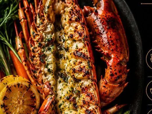 Grilled butter lobster with garlic herb sauce, mashed potato and grilled lemon